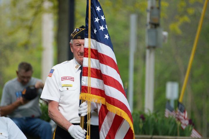 veteran with an american flag on veterans day