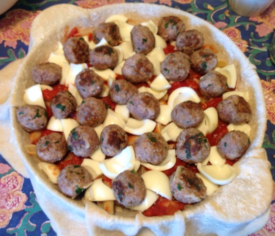 layering the timpano traditional italian dish