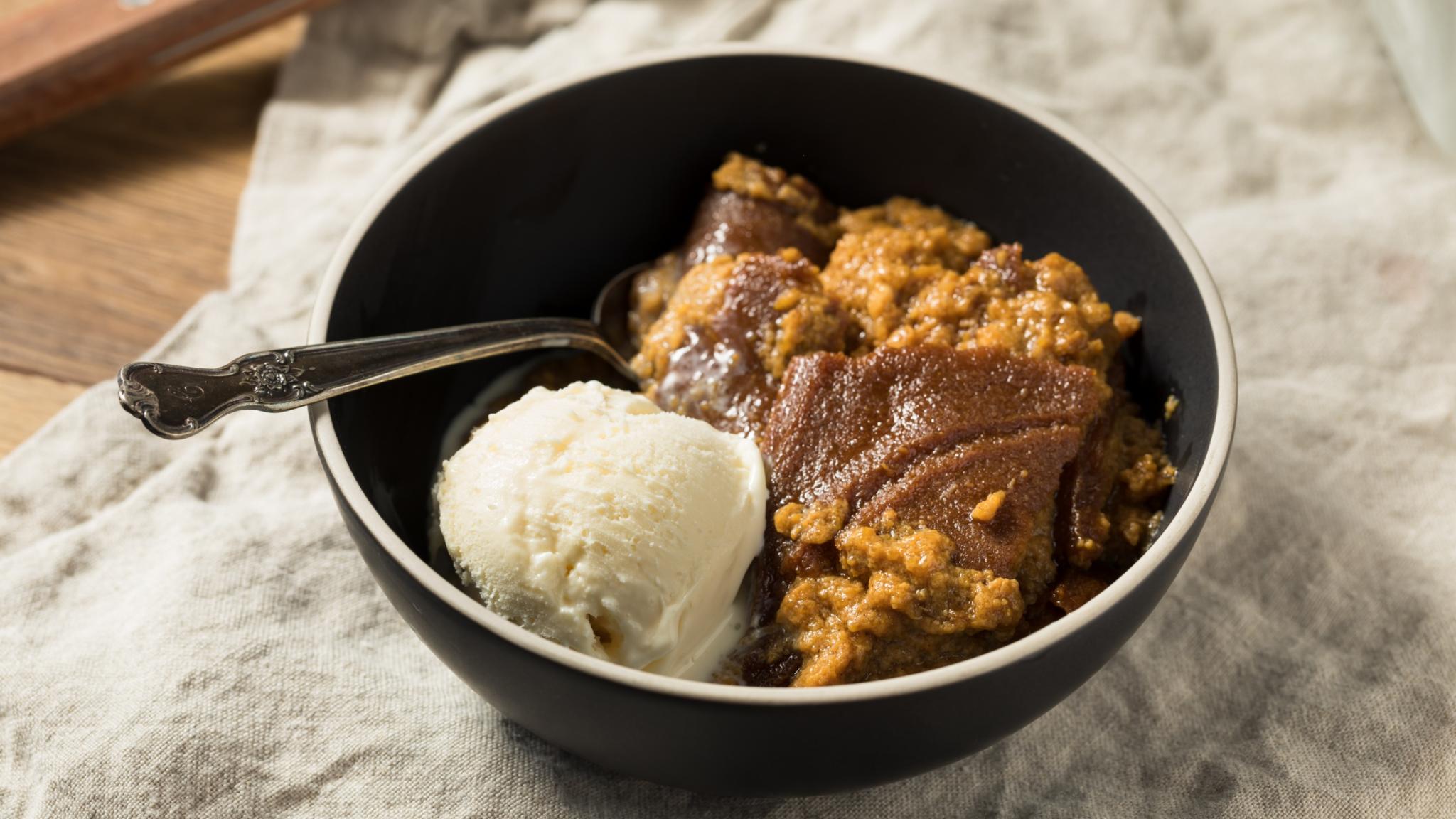 indian pudding in a bowl with ice cream