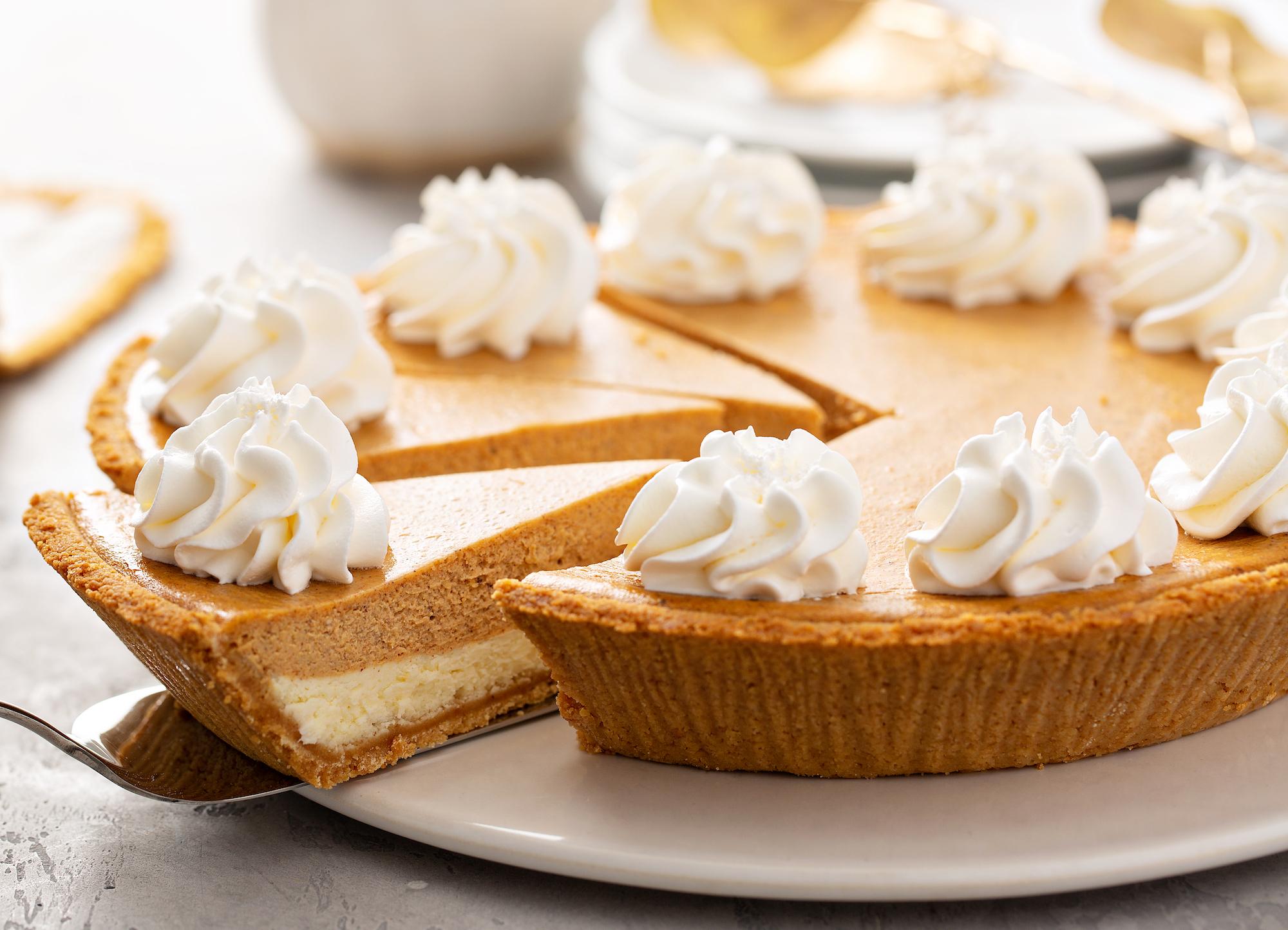 pumpkin satin cheesecake with whipped cream dollops