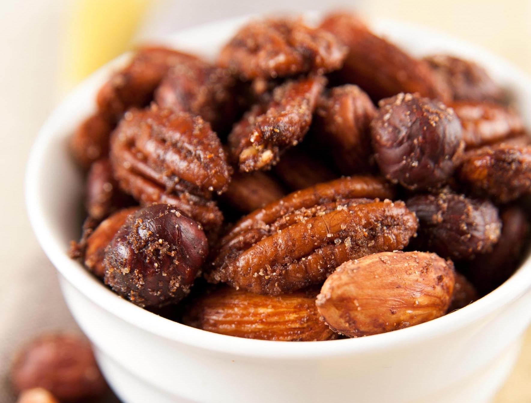 spiced nuts (almonds, hazelnuts, and pecans) in a white dish