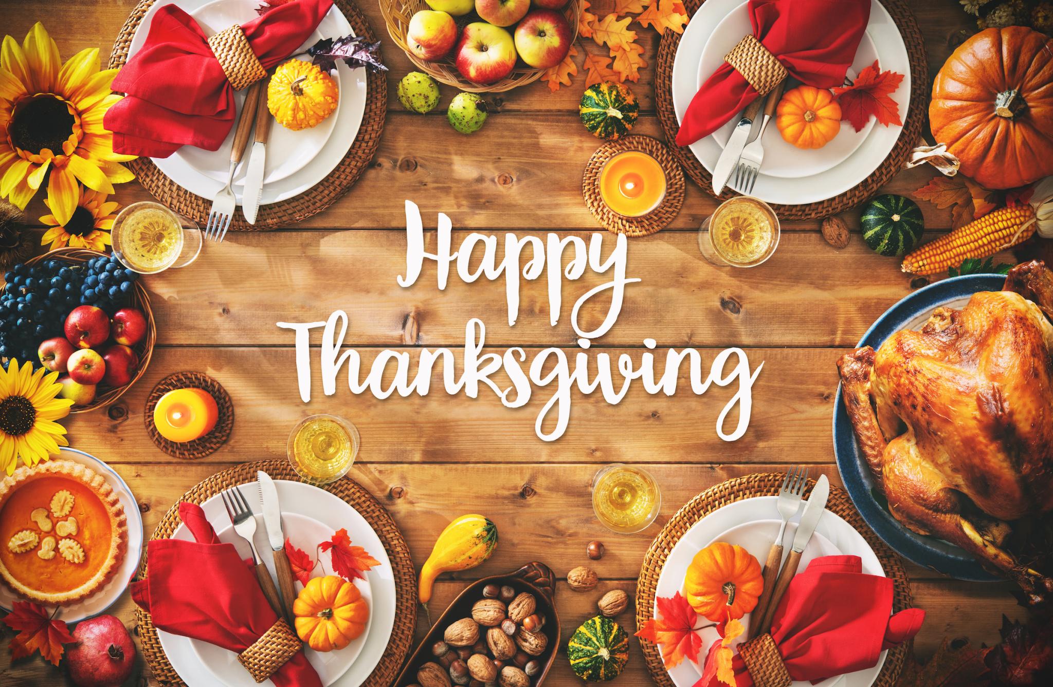 Happy Thanksgiving image with a feast and a table setting