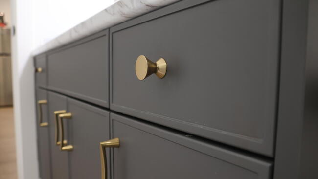 Gold Cabinet Hardware in white bathroom