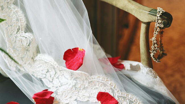 Wedding Veil on a chair with rose petals
