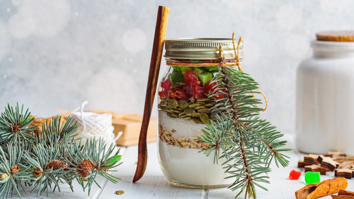 Christmas cookie mix jar. Dry ingredients for making Christmas cookies in a jar, white background.