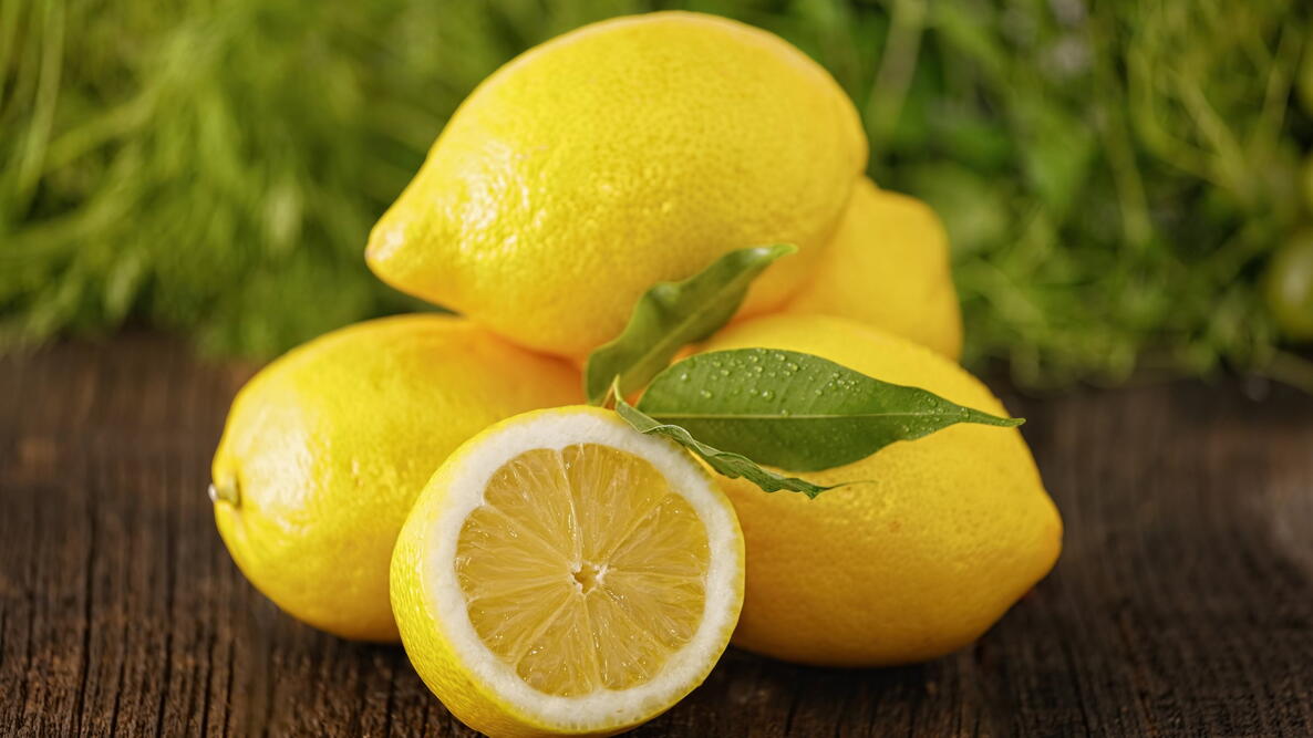 Pile of fresh lemons on wooden board