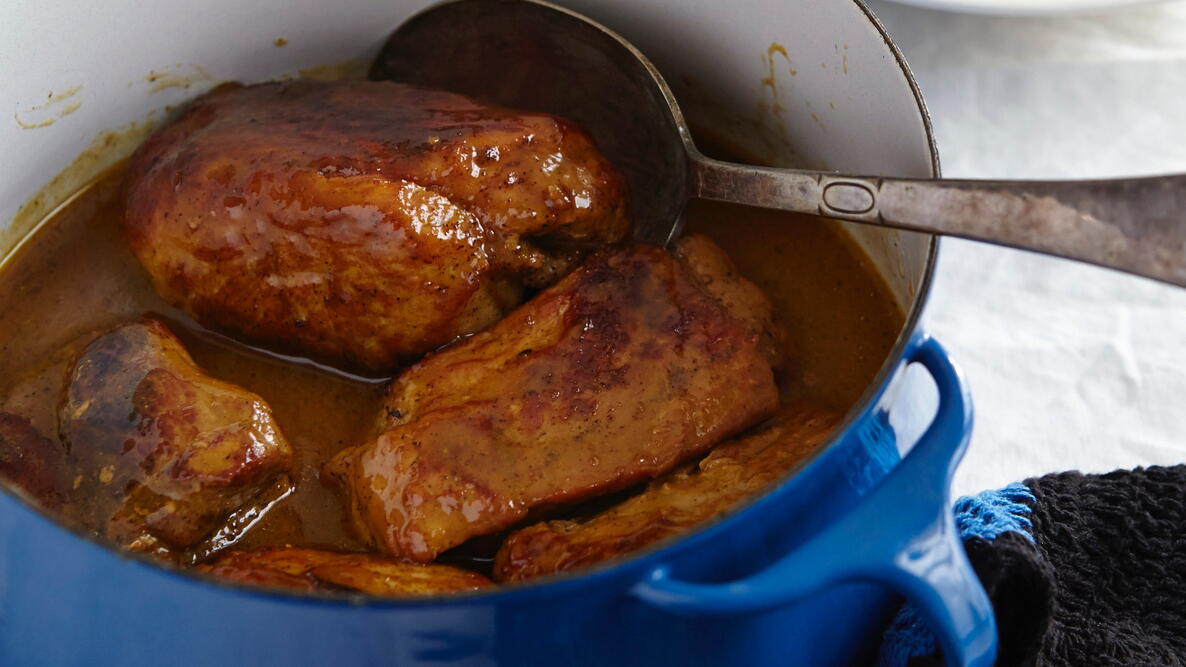 Juicy pork strips in a blue pot 