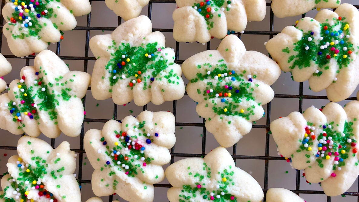 Holiday spritz cookies on a wire cooling rack