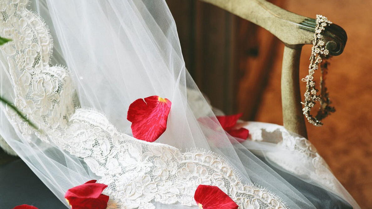 Wedding Veil on a chair with rose petals
