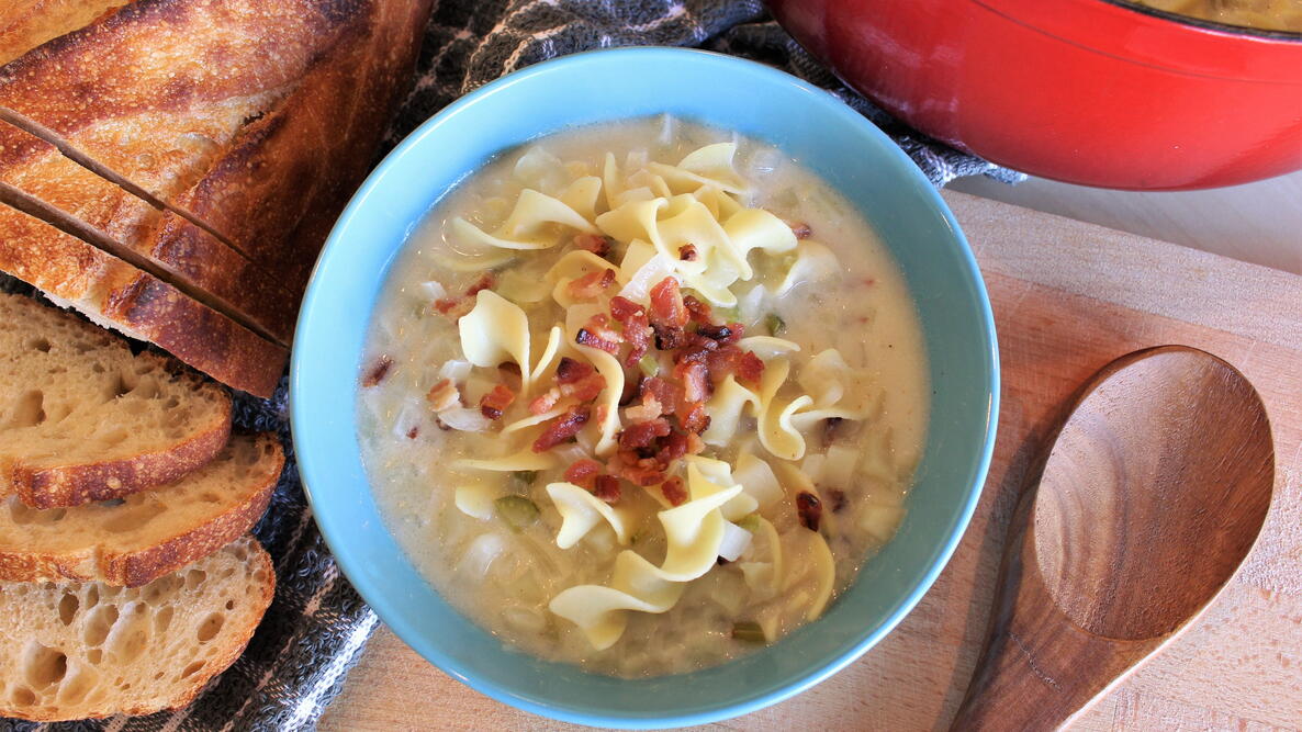 bowl of German potato soup with wooden spoon