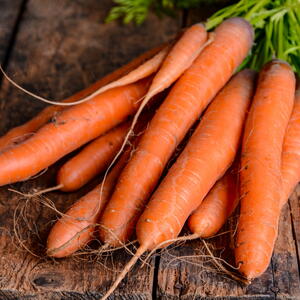 clean carrots on a wooden table