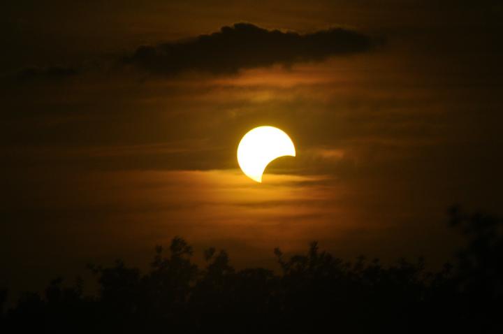 a partial solar eclipse in the sky