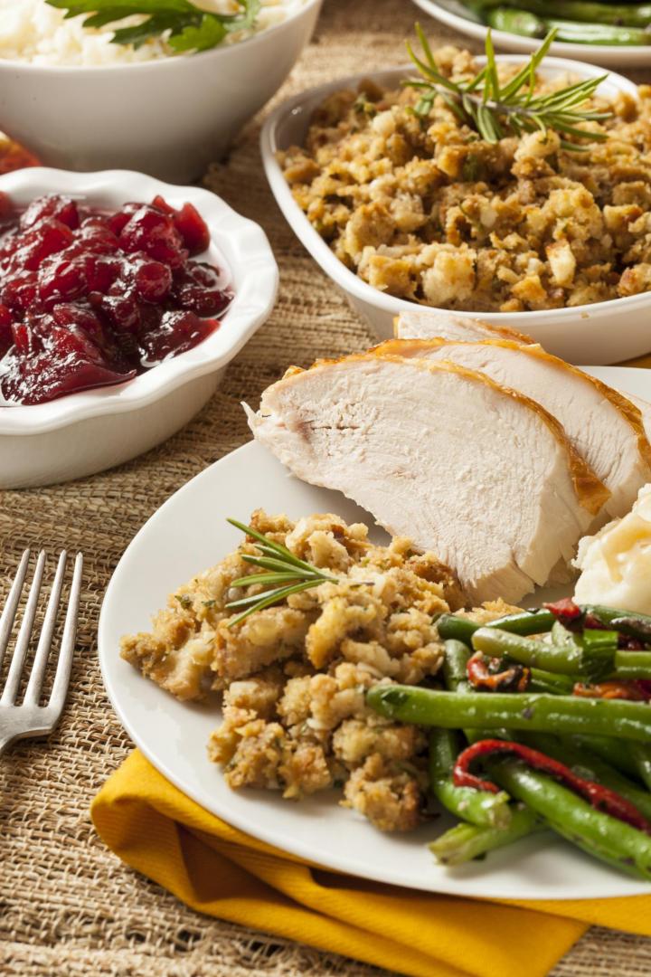 traditional thanksgiving feast with turkey, cranberry sauce, and stuffing