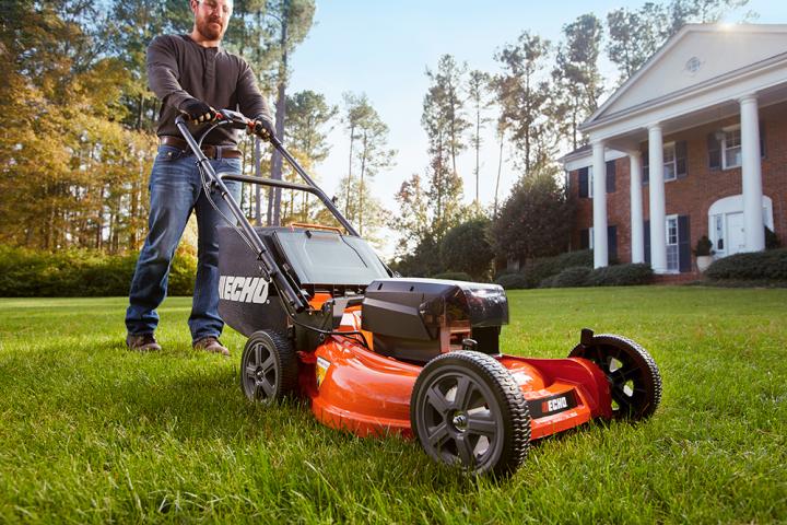 Cutting the grass with an electric cordless lawn mower