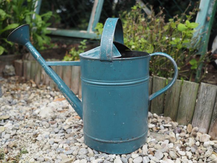 green metal watering can