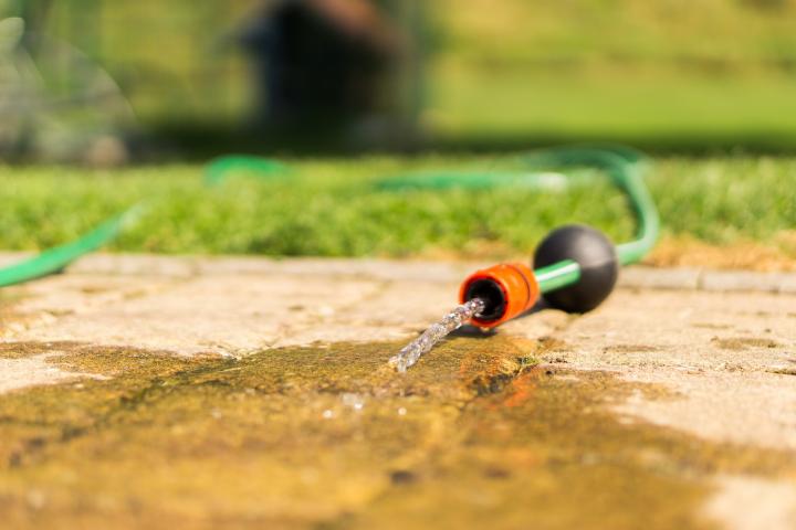 Water hose spilling on the concrete